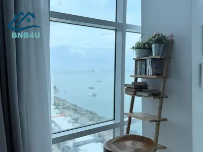 a book shelf next to a window with a plant at Duplex Comfort Stay in George Town in George Town