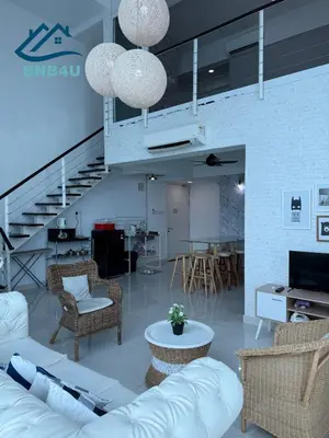 a living room with a couch and chairs and a staircase at Duplex Comfort Stay in George Town in George Town