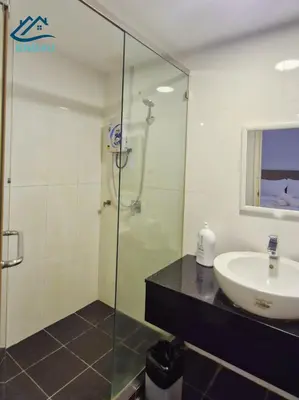a bathroom with a sink and a glass shower at Duplex Comfort Stay in George Town in George Town
