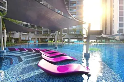 a row of pink loungers in a swimming pool at Rich Return Empire in Gua Sai