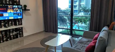 a living room with a couch and a large window at Rich Return Empire in Gua Sai