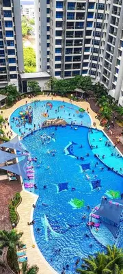 a large swimming pool in a large building at Rich Return Empire in Gua Sai