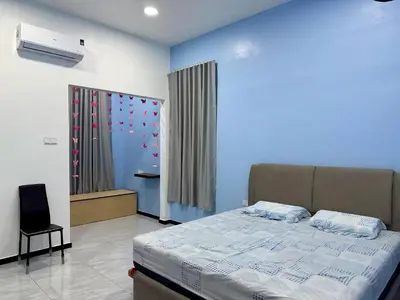 a bedroom with a bed and a window with hearts on the wall at \u5feb\u4e50\u5ba2\u6808 Sentosa Cottage in Raub