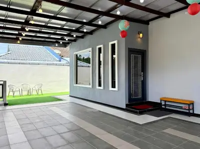 a house with a porch with a bench and chairs at \u5feb\u4e50\u5ba2\u6808 Sentosa Cottage in Raub