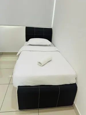 a black and white bed with a white phone on it at Seaview Condo A31 #Queensbay#SPICE in Bayan Lepas