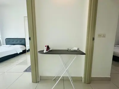 a table in the corner of a room with a bed at Seaview Condo A31 #Queensbay#SPICE in Bayan Lepas