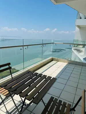 a bench on the roof of a building with a view of the ocean at Seaview Condo A31 #Queensbay#SPICE in Bayan Lepas