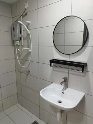 a bathroom with a sink and a mirror at Studio Unit Marc Residence in Bukit Mertajam