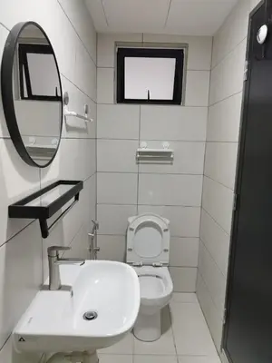 a bathroom with a sink and a toilet and a mirror at Studio Unit Marc Residence in Bukit Mertajam