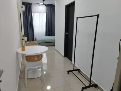 a room with a white table and a mirror at Studio Unit Marc Residence in Bukit Mertajam