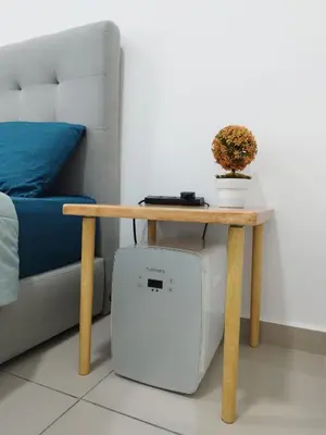 a table next to a bed and a table with a computer at Studio Unit Marc Residence in Bukit Mertajam