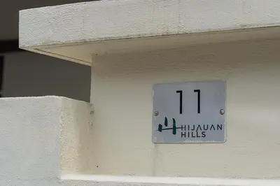 a clock on the side of a building with the number at Bright & Airy Double-Storey Retreat 4BR in Simpang Ampat