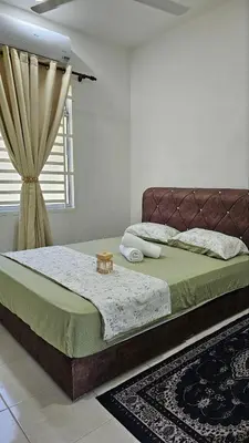 a bedroom with a large bed and a window at Neera Rest House in Gua Sai