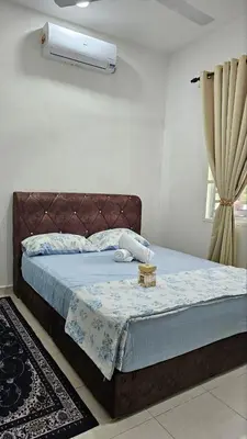 a bedroom with a bed with a blue blanket at Neera Rest House in Gua Sai