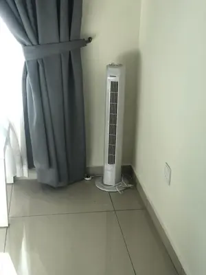 a radiator sitting next to a window with a curtain at Rayyan'Homestay PMCJ in Tanah Rata
