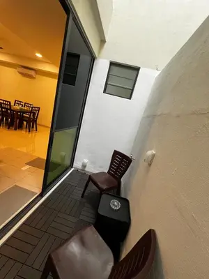 a balcony with two chairs and a table and chairs at AP Homestay in Sekincan