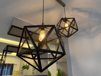 a cluster of lights hanging from a ceiling at Serenity Haven Family Stay Ipoh 10-12 Pax in Ipoh