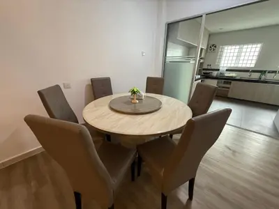 a dining room with a wooden table and chairs at Serenity Haven Family Stay Ipoh 10-12 Pax in Ipoh