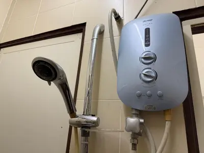 a soap dispenser on a wall next to a door at Serenity Haven Family Stay Ipoh 10-12 Pax in Ipoh