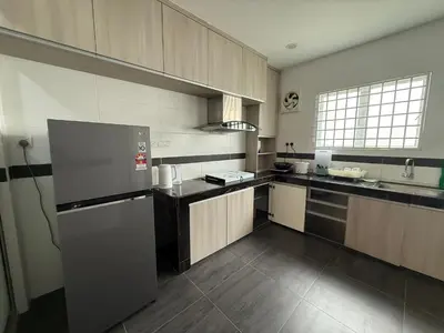 a kitchen with a stainless steel refrigerator and cabinets at Serenity Haven Family Stay Ipoh 10-12 Pax in Ipoh