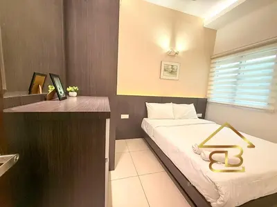 a bedroom with a bed with a gold sign on it at Ipoh City Centre Penthouse 12-15 Pax KTV BBQ in Ipoh
