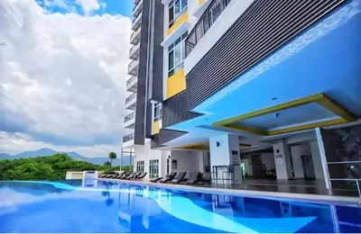 a hotel with a swimming pool in front of a building at Ipoh City Centre Penthouse 12-15 Pax KTV BBQ in Ipoh