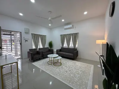 a living room with two couches and a table at Harees Homestay in Kuala Lipis