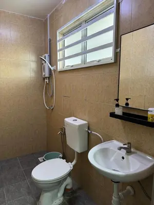 a bathroom with a toilet and a sink at Harees Homestay in Kuala Lipis