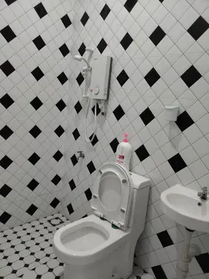 a bathroom with a toilet and a sink at Makwan Homestay D in Kubang Semang
