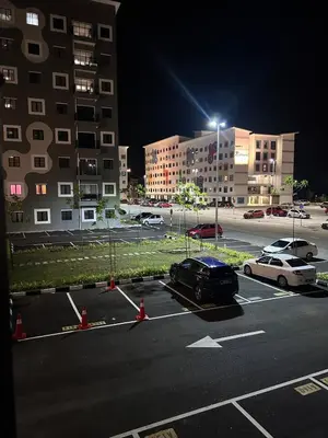 a car parked in a parking lot at night at WiU Cottage, Seri Iskandar in Seri Iskandar