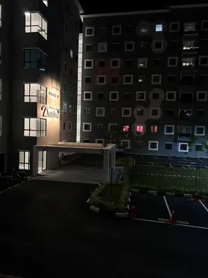 an empty parking lot in front of a building at night at WiU Cottage, Seri Iskandar in Seri Iskandar