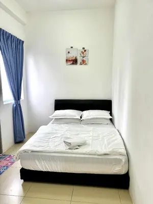 a white bed in a bedroom with a blue curtain at AYAAN ORCHID Fifa Home at Golden Hill Night Market in Brinchang