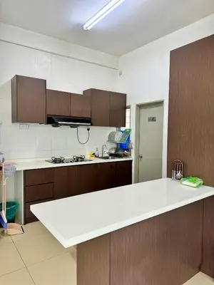 a kitchen with a white counter top and wooden cabinets at AYAAN ORCHID Fifa Home at Golden Hill Night Market in Brinchang