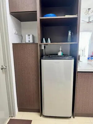 a small refrigerator in a kitchen with a shelf at AYAAN ORCHID Fifa Home at Golden Hill Night Market in Brinchang