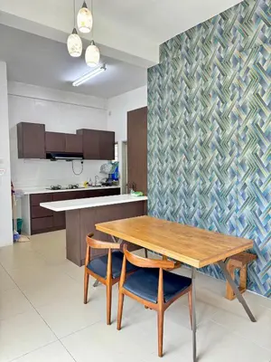 a kitchen with a wooden table and two chairs at AYAAN ORCHID Fifa Home at Golden Hill Night Market in Brinchang