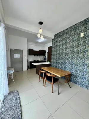 a living room with a wooden table and a kitchen at AYAAN ORCHID Fifa Home at Golden Hill Night Market in Brinchang