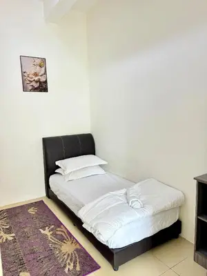 a bedroom with a bed and a rug at AYAAN ORCHID Fifa Home at Golden Hill Night Market in Brinchang