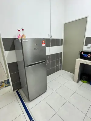 a kitchen with a stainless steel refrigerator in a room at Ayaan Fifa Home Juniors with Netflix and Ps4 Games in Tanah Rata