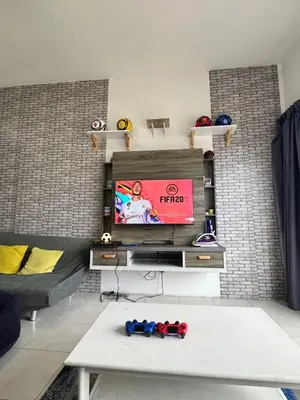a living room with a tv and a couch at Ayaan Fifa Home Juniors with Netflix and Ps4 Games in Tanah Rata
