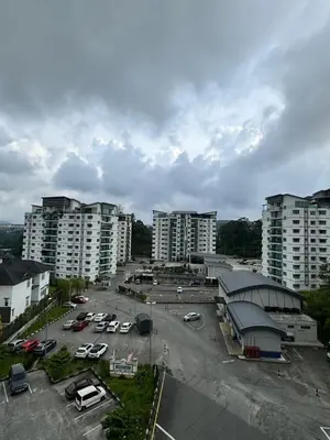 a parking lot in a city with tall buildings at Ayaan Fifa Home Juniors with Netflix and Ps4 Games in Tanah Rata