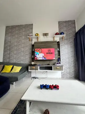 a living room with a couch and a tv at Ayaan Fifa Home Juniors with Netflix and Ps4 Games in Tanah Rata