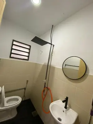 a bathroom with a mirror and a toilet and a sink at Asu Homestay w Private Pool - Batu Gajah,Perak in Batu Gajah