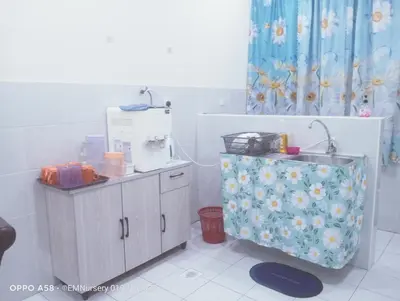 a kitchen with a sewing machine sitting on a counter at Homestay Bajet EM1 Pantai Remis PK in Pantai Remis