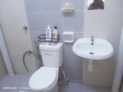 a bathroom with a toilet and a sink at Homestay Bajet EM1 Pantai Remis PK in Pantai Remis
