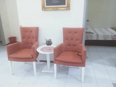 two chairs and a table in a room at Homestay Bajet EM1 Pantai Remis PK in Pantai Remis