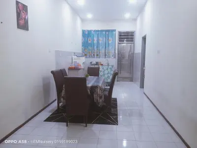 a kitchen and dining room with a table and chairs at Homestay Bajet EM1 Pantai Remis PK in Pantai Remis