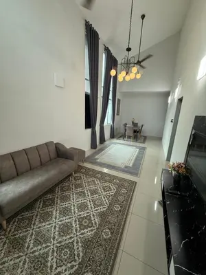 a living room with a couch and a table at Tropika Homestay Ipoh in Ipoh