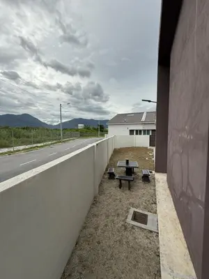 a concrete wall with a picnic table on the side of a road at Tropika Homestay Ipoh in Ipoh
