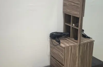 a telephone is sitting in a wooden book shelf at \u7a3b\u5cb8 DaoAn Homestay-with balcony in Sekincan