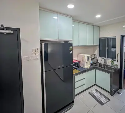 a kitchen with a black refrigerator and white cabinets at \u7a3b\u5cb8 DaoAn Homestay-with balcony in Sekincan